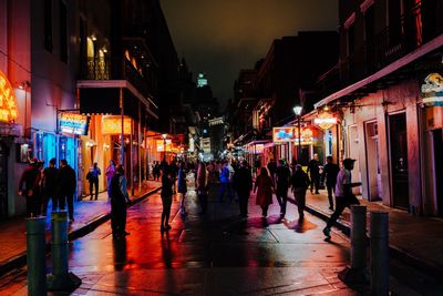 People on illuminated city at night