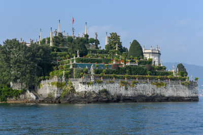 Panoramic view of trees and building against sky