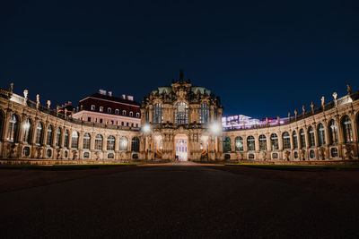 Illuminated building against sky at night