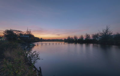 Scenic view of lake against sky during sunset