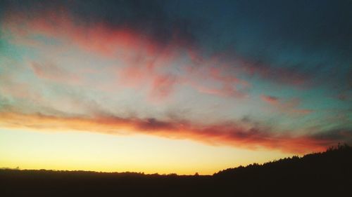 Silhouette landscape against dramatic sky