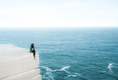 Rear view of man walking on beach