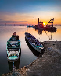 Boats moored at harbor