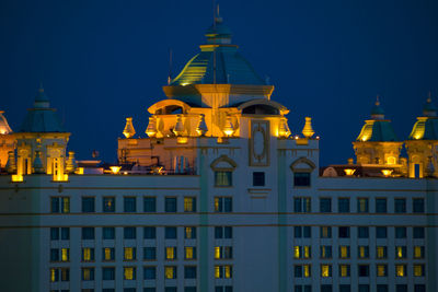 Low angle view of illuminated buildings at night