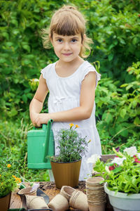 Rear view of girl picking plants