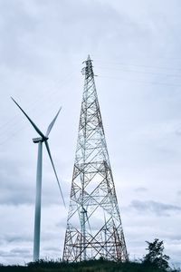 Low angle view of electricity pylon against sky