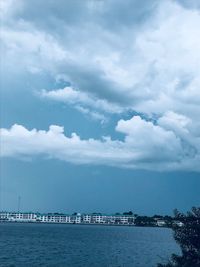 Scenic view of sea by buildings against sky