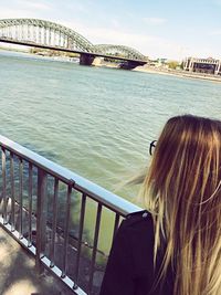 Rear view of woman on bridge over river