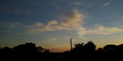 Silhouette trees against sky during sunset