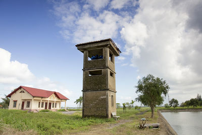 Tower on field against sky