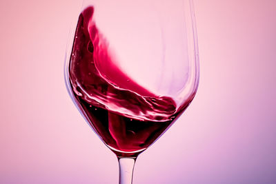 Close-up of drink in glass against white background