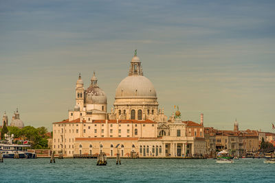 View of buildings at waterfront against sky