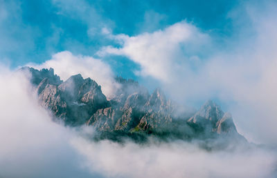 Clouds over mountain peaks in the dolomites, italy.