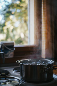 Close-up of potatoes boiling in saucepan on stove