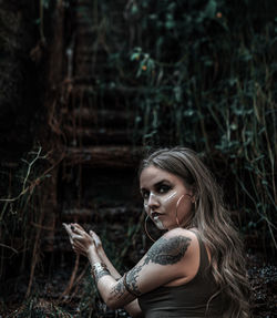 Portrait of young woman in forest