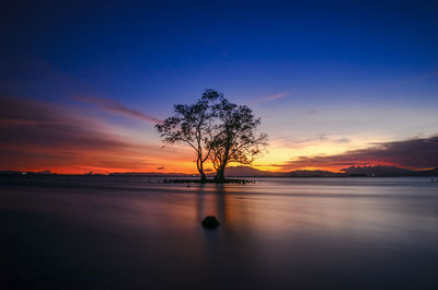 Scenic view of lake against romantic sky at sunset