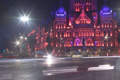 Illuminated city street and buildings at night