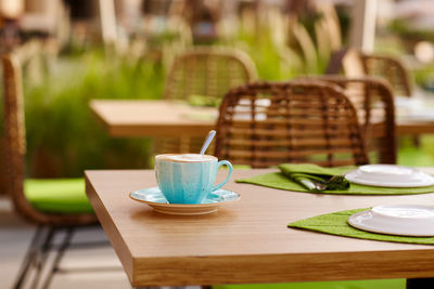 Morning coffee on the cozy cafe terrace. a cup of coffee is on a table in an outdoor cafe