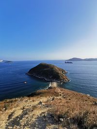 Scenic view of sea against clear blue sky