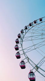 Low angle view of ferris wheel against clear sky