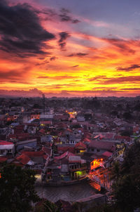 High angle view of illuminated buildings against sky during sunset