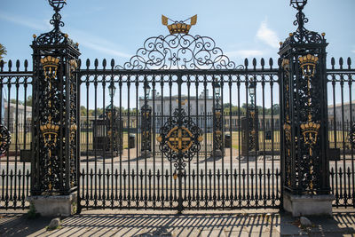 View of metal gate against sky