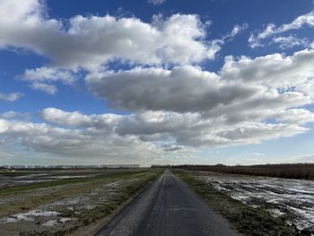 Empty road along countryside landscape