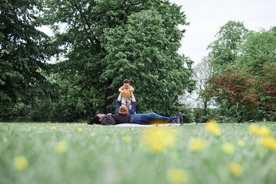 Relaxed parents playing with son at park