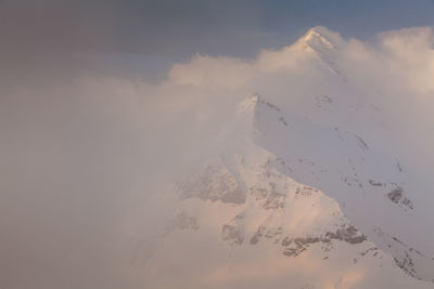 Aerial view of snowcapped mountain against sky