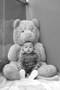 Portrait of cute boy sitting toy