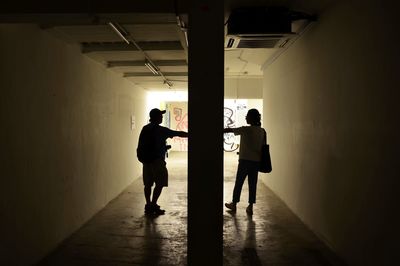 Silhouette of man standing in corridor