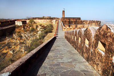 Walkway at jaigarh fort against clear blue sky