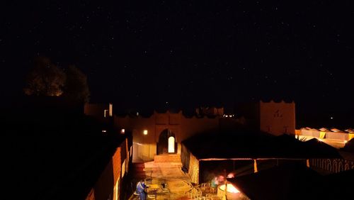 Illuminated city against sky at night