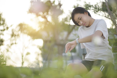 Young woman sitting outdoors