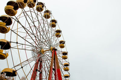 Low angle view of ferris wheel against clear sky