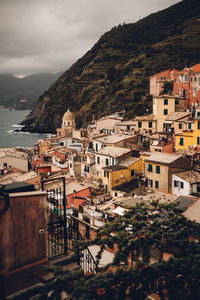 High angle view of townscape by sea against sky