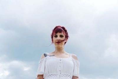 Portrait of woman against sky