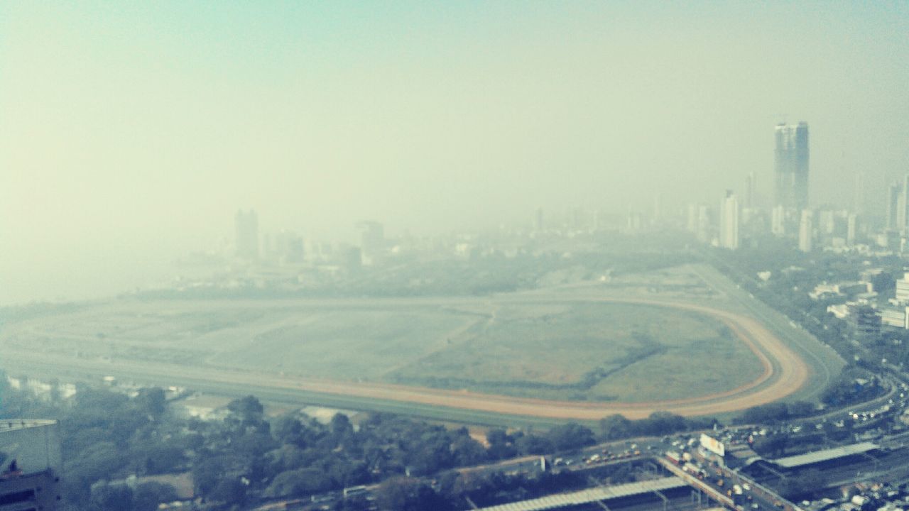 built structure, architecture, building exterior, cityscape, fog, city, high angle view, landscape, copy space, weather, winter, foggy, aerial view, transportation, road, cold temperature, nature, field, snow