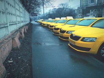 Taxis parked in row on wet road