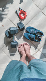 Low section of man standing on tiled floor