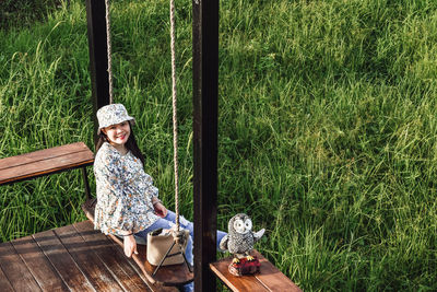 Portrait of a smiling young woman sitting on grass