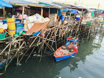 Boat moored in river by market