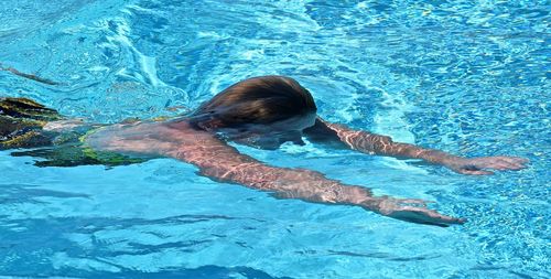 High angle view of woman swimming in pool