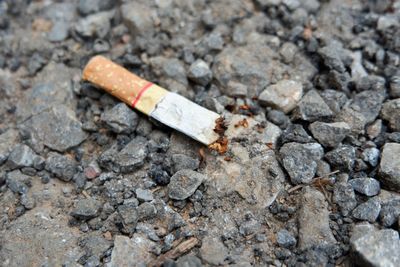 Close-up of cigarette on ground