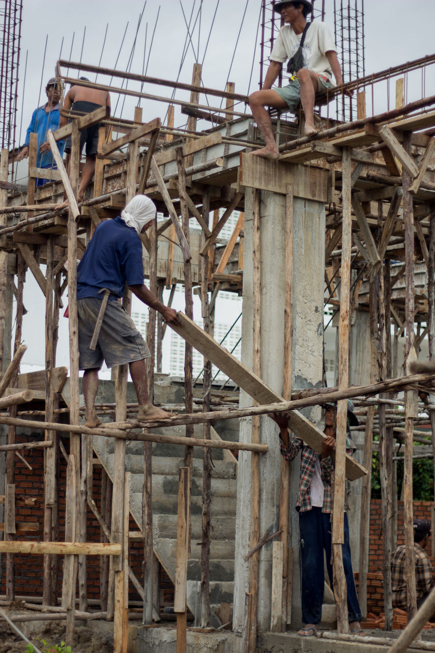 LOW ANGLE VIEW OF WORKERS WORKING