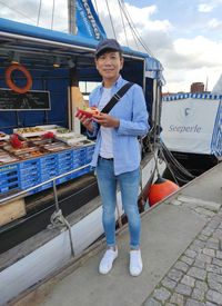 Rear view of man standing in boat