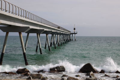 Pier over sea against sky