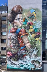 Portrait of woman holding multi colored painting