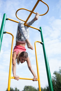 Low angle view of girl playing in playground