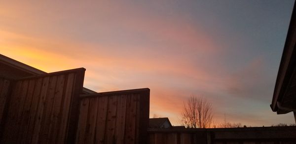 Low angle view of silhouette building against sky during sunset